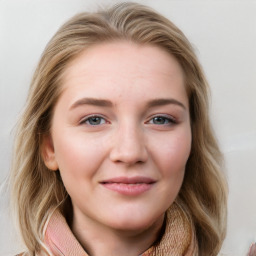 Joyful white young-adult female with long  brown hair and blue eyes