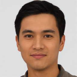 Joyful asian young-adult male with short  black hair and brown eyes