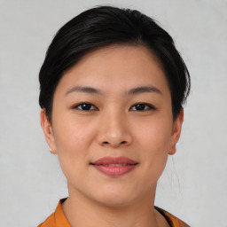 Joyful asian young-adult female with short  black hair and brown eyes