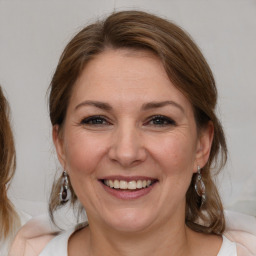 Joyful white adult female with medium  brown hair and brown eyes