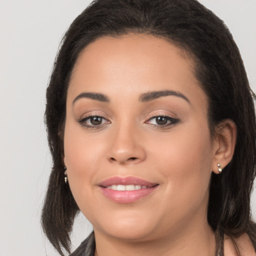 Joyful white young-adult female with long  brown hair and brown eyes