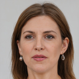 Joyful white adult female with long  brown hair and grey eyes