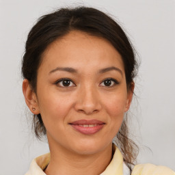 Joyful latino young-adult female with medium  brown hair and brown eyes