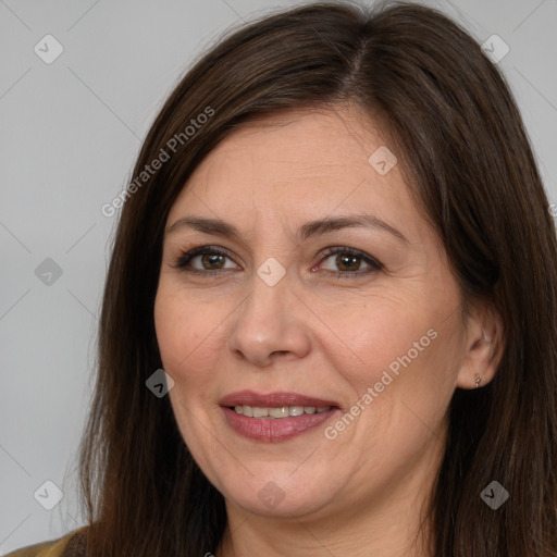 Joyful white adult female with long  brown hair and brown eyes