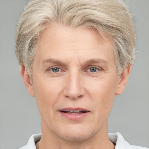 Joyful white adult male with short  blond hair and grey eyes