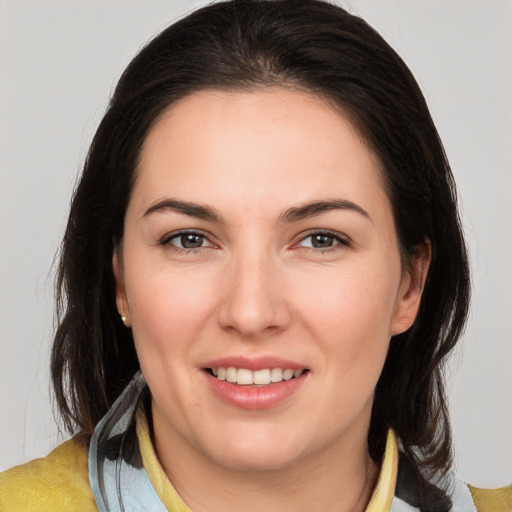 Joyful white young-adult female with medium  brown hair and brown eyes