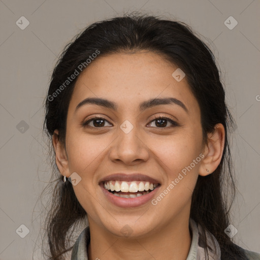 Joyful latino young-adult female with long  brown hair and brown eyes