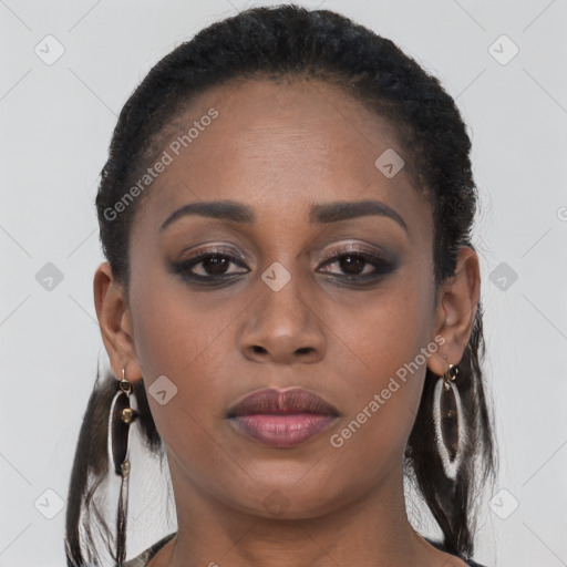 Joyful black young-adult female with long  brown hair and brown eyes