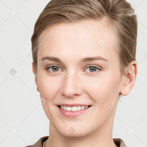 Joyful white young-adult female with short  brown hair and grey eyes