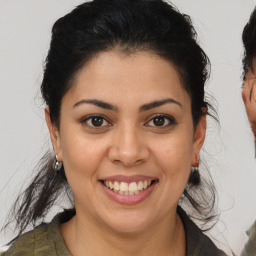 Joyful latino young-adult female with medium  brown hair and brown eyes