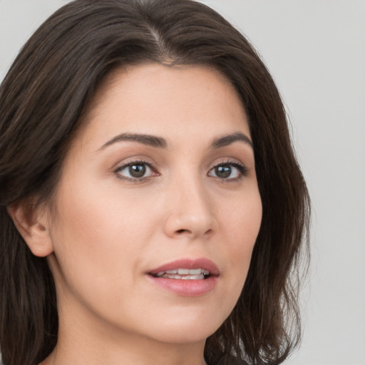 Joyful white young-adult female with medium  brown hair and brown eyes