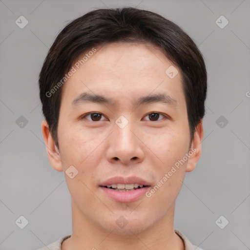 Joyful asian young-adult male with short  brown hair and brown eyes