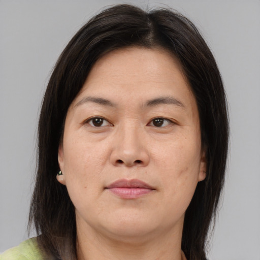 Joyful asian adult female with medium  brown hair and brown eyes