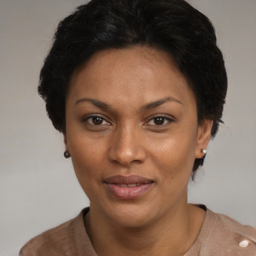 Joyful black adult female with short  brown hair and brown eyes