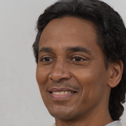 Joyful black adult male with short  brown hair and brown eyes