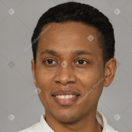 Joyful black young-adult male with short  black hair and brown eyes