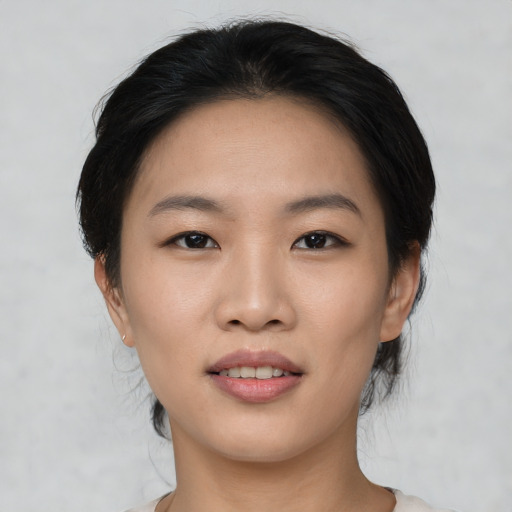 Joyful asian young-adult female with short  black hair and brown eyes