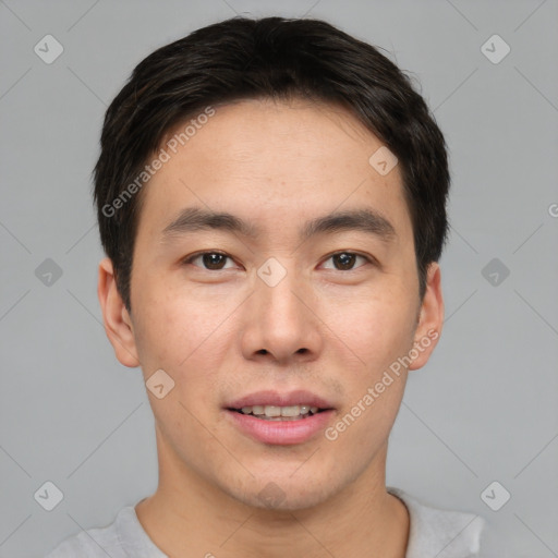 Joyful asian young-adult male with short  brown hair and brown eyes