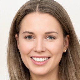 Joyful white young-adult female with long  brown hair and grey eyes