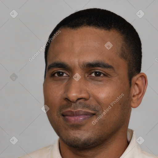 Joyful black young-adult male with short  black hair and brown eyes