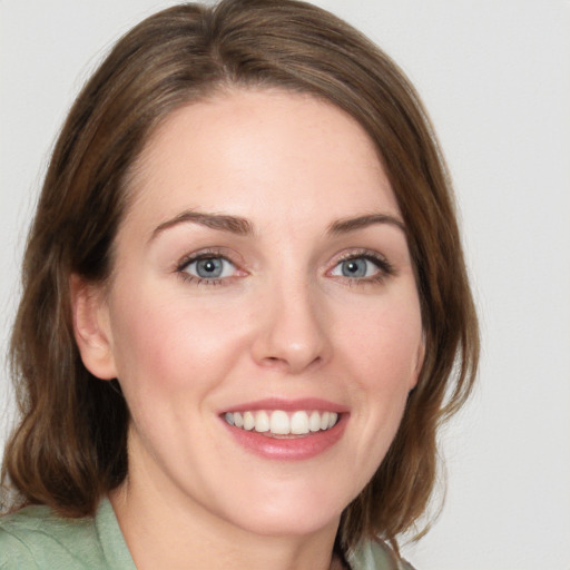 Joyful white young-adult female with medium  brown hair and green eyes