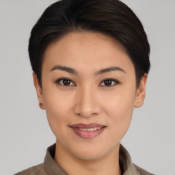 Joyful asian young-adult female with short  brown hair and brown eyes