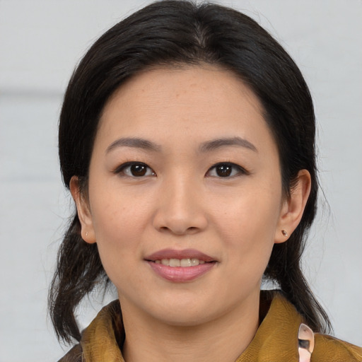 Joyful asian young-adult female with medium  brown hair and brown eyes