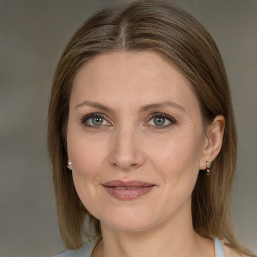 Joyful white adult female with medium  brown hair and grey eyes