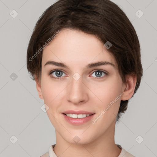 Joyful white young-adult female with short  brown hair and grey eyes