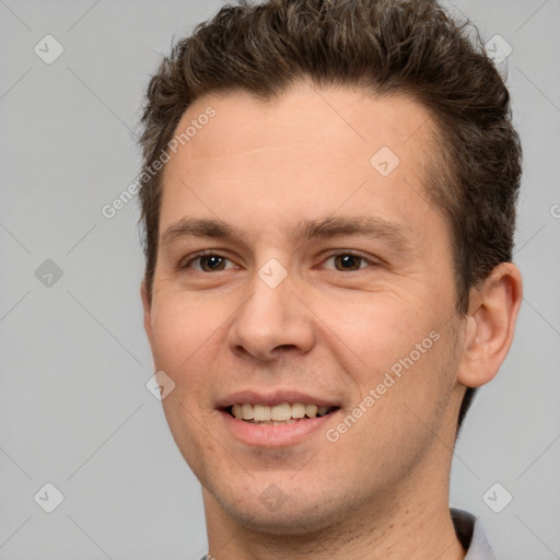 Joyful white adult male with short  brown hair and brown eyes