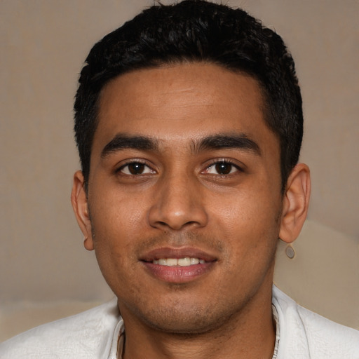 Joyful latino young-adult male with short  black hair and brown eyes