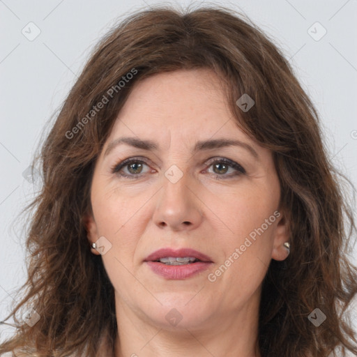 Joyful white adult female with long  brown hair and brown eyes