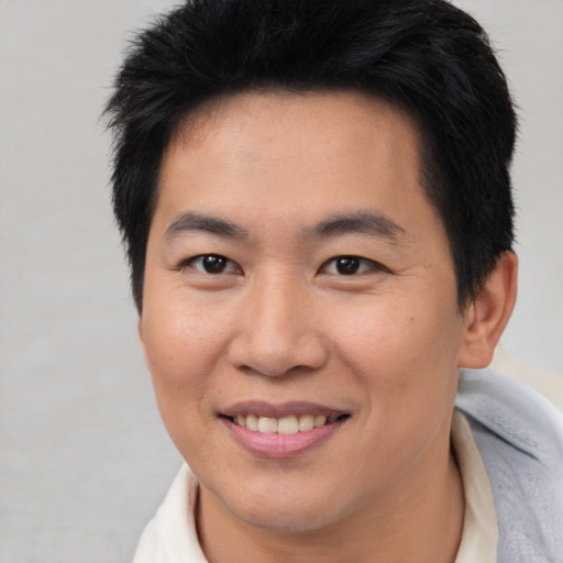 Joyful asian young-adult female with short  brown hair and brown eyes