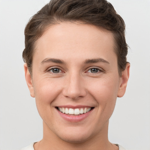 Joyful white young-adult female with short  brown hair and brown eyes