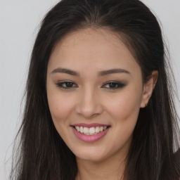 Joyful asian young-adult female with long  brown hair and brown eyes