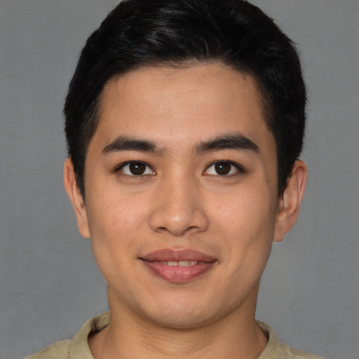 Joyful latino young-adult male with short  brown hair and brown eyes