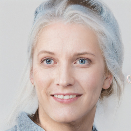 Joyful white adult female with medium  blond hair and blue eyes