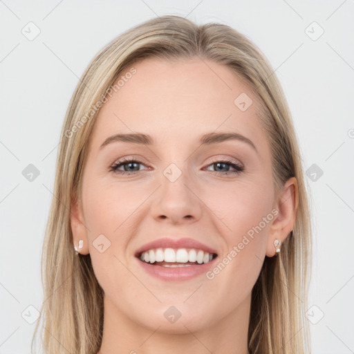 Joyful white young-adult female with long  brown hair and blue eyes