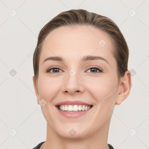 Joyful white young-adult female with short  brown hair and grey eyes