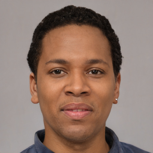 Joyful latino young-adult male with short  brown hair and brown eyes