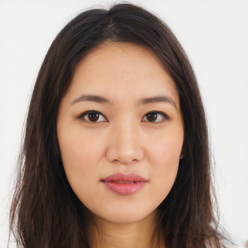 Joyful asian young-adult female with long  brown hair and brown eyes
