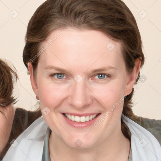 Joyful white young-adult female with medium  brown hair and blue eyes