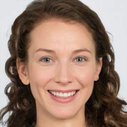 Joyful white young-adult female with long  brown hair and green eyes