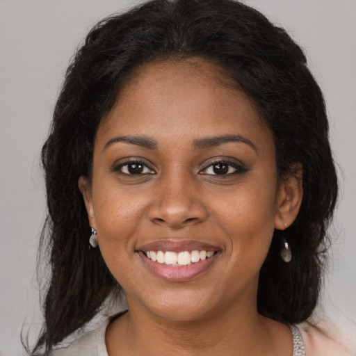 Joyful black young-adult female with medium  brown hair and brown eyes