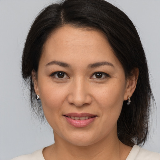 Joyful white adult female with medium  brown hair and brown eyes