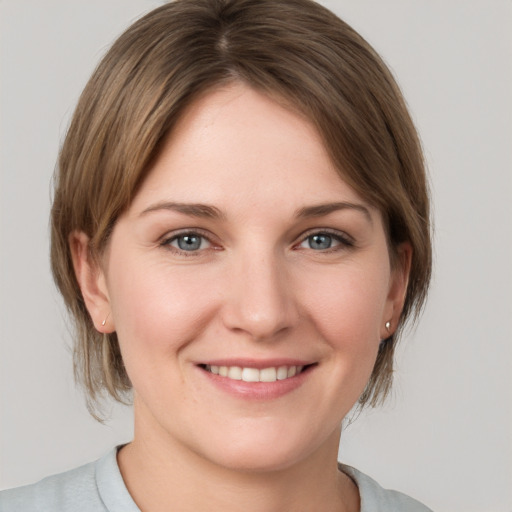 Joyful white young-adult female with medium  brown hair and grey eyes