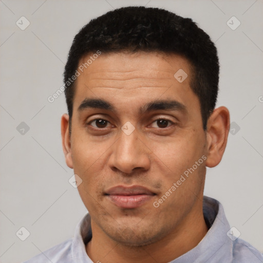 Joyful latino young-adult male with short  black hair and brown eyes