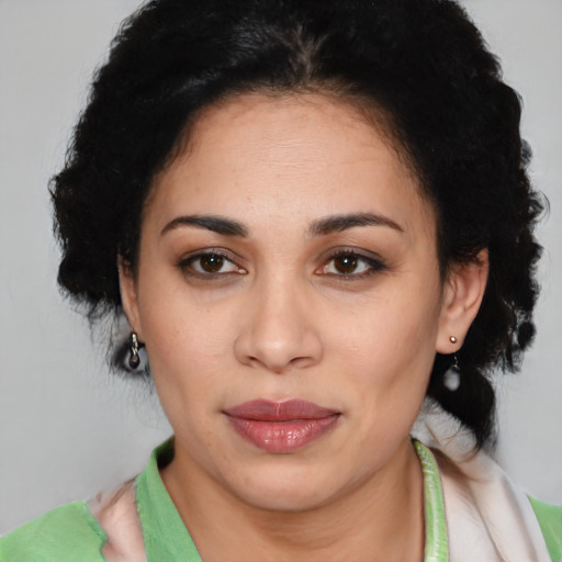 Joyful latino young-adult female with medium  black hair and brown eyes