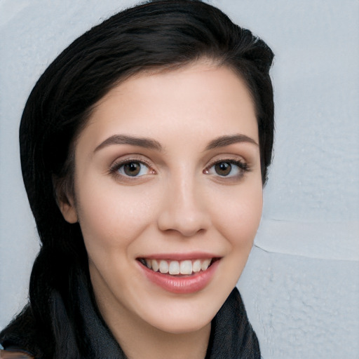 Joyful white young-adult female with long  black hair and brown eyes