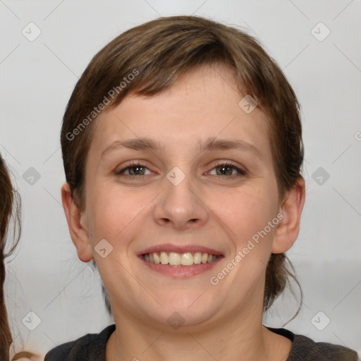 Joyful white young-adult female with medium  brown hair and grey eyes